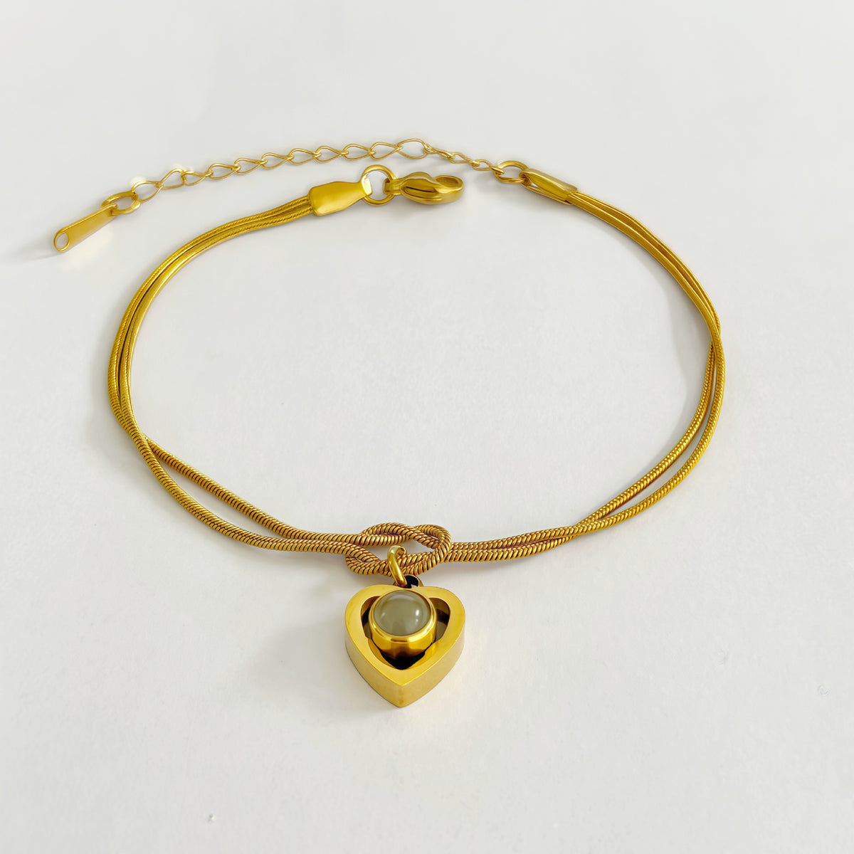 Infinity knot bracelet with custom projection stone