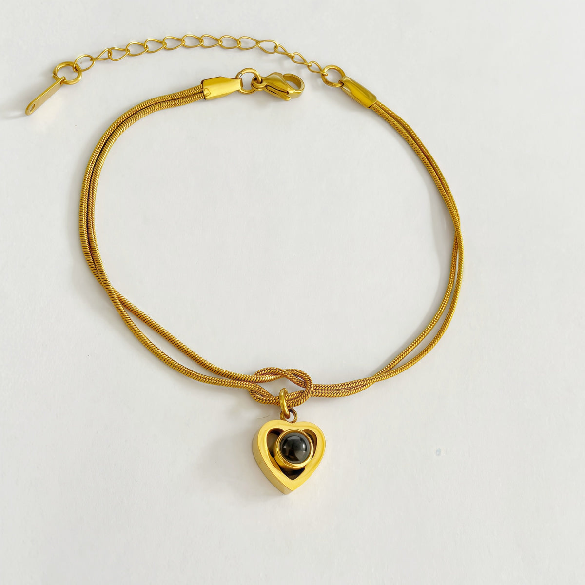 Phone camera viewing custom photo inside heart pendant