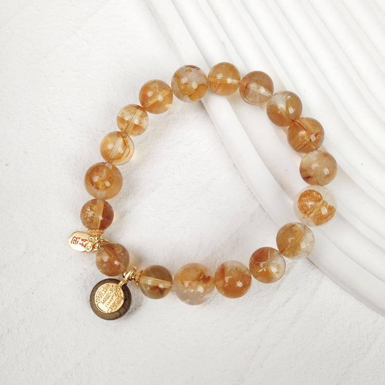 Natural golden rutilated quartz bracelet with agarwood and gold plated copper charm