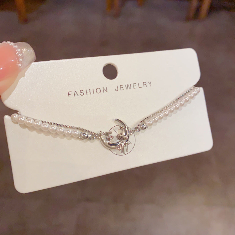 Pearl accents with butterfly and moon details