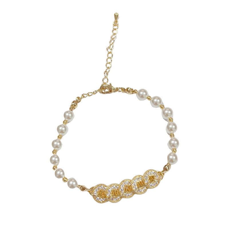 Gold plated faux pearl bracelet with sparkling zircon stones