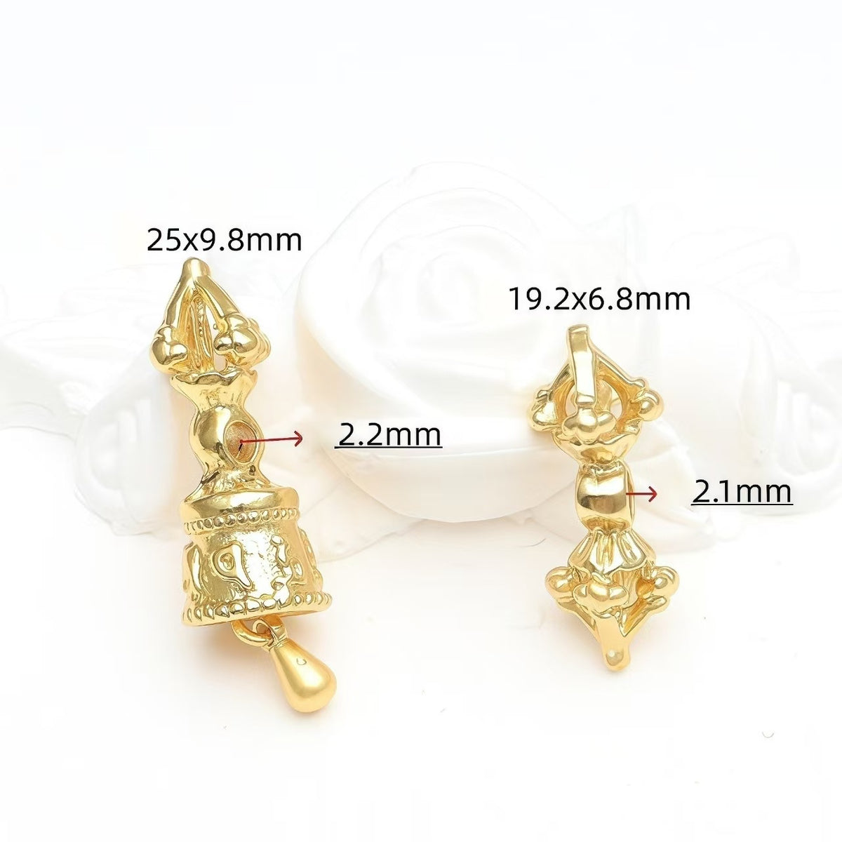 Gold vajra pendant and vajra bell with engraved detail
